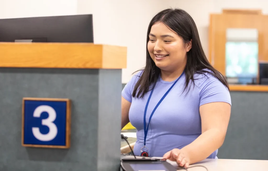 Friendly Gesa Credit Union teller assisting a member at service window number 3.