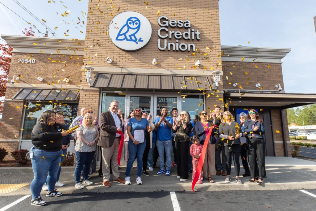 Gesa Credit Union celebrates the grand opening of its new Kent branch with a ribbon-cutting ceremony and community members.